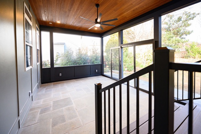 Modern screened-in porch patio enclosure with ceiling fan, wood ceiling, and screened walls for outdoor living