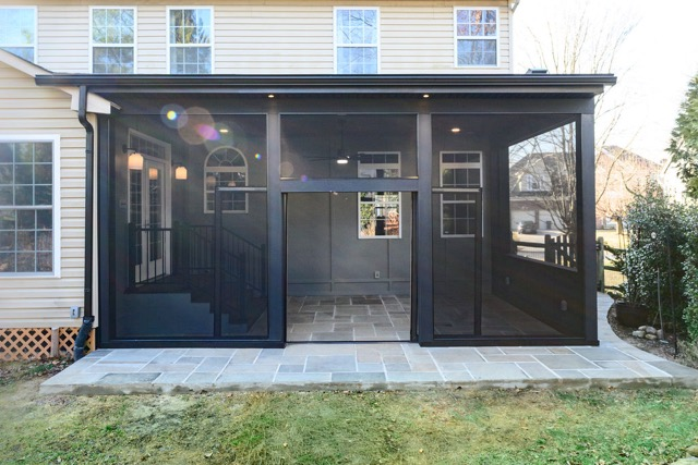 Modern screened-in porch patio enclosure with ceiling fan, wood ceiling, and screened walls for outdoor living