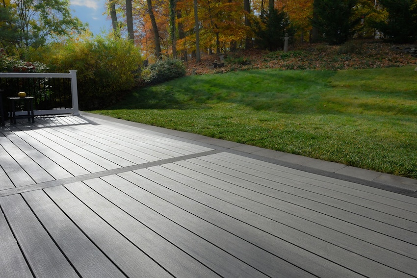  White composite railing with black aluminum balusters installed on a custom Columbia deck project.