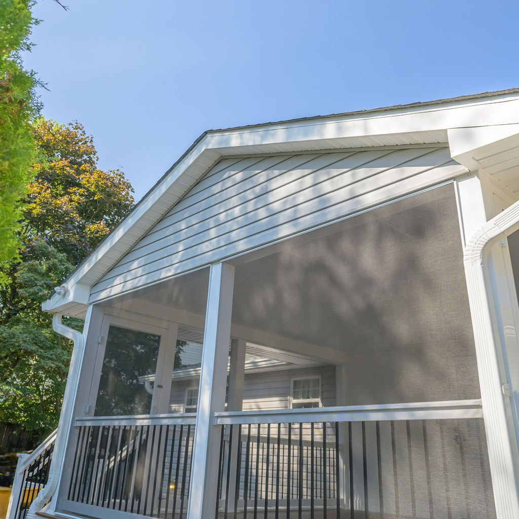 catonsville-screened-in-porch-exterior-trex-decking - thefinalcuthomeimprovementllc.com Custom screened-in porch in Catonsville MD featuring Trex Saddle decking and white railing system