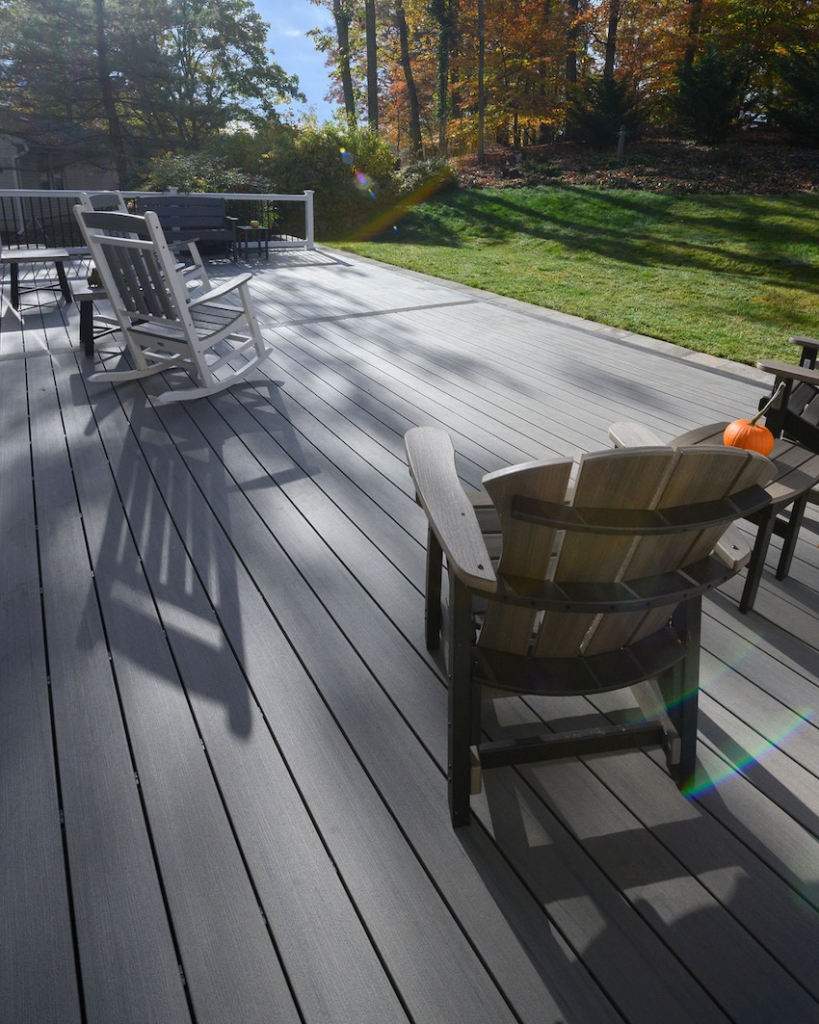 Custom composite deck in Columbia, Maryland featuring TimberTech Sea Salt Gray decking and outdoor seating.