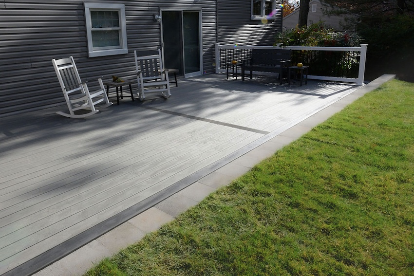 Deckorators Dark Slate picture-frame border accent surrounding TimberTech Sea Salt Gray composite decking.