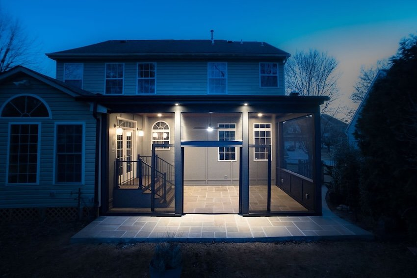 Custom screened patio enclosure with stone flooring, recessed lighting, and expansive screen panels in Columbia, Maryland.
