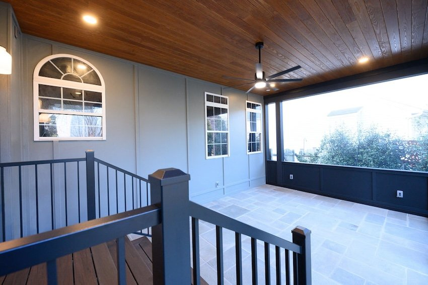  Luxury screened porch with natural stone flooring, dark architectural accents, and expansive screened openings in Columbia, MD.