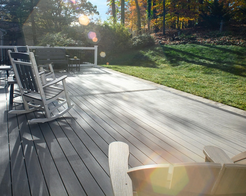 The Final Cut team cleaning TimberTech Sea Salt Gray composite decking during a custom deck installation in Columbia, MD.