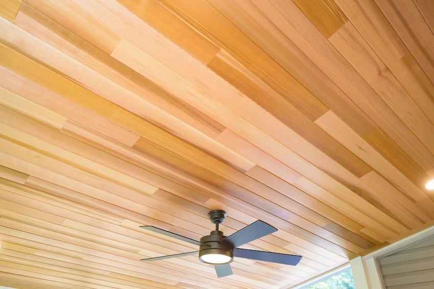 Trex Saddle decking paired with clear cedar ceiling in custom screened porch