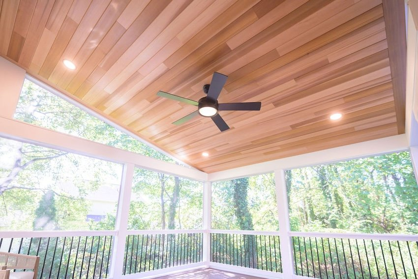 Vaulted clear cedar ceiling with recessed lighting and ceiling fan in screened porch